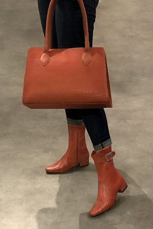 Terracotta orange women's ankle boots with buckles on the sides. Round toe. Low block heels. Worn view - Florence KOOIJMAN
